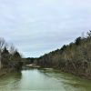 Rippling water in large creek with sandbar in the background