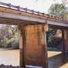 Under side of concrete highway bridge and river