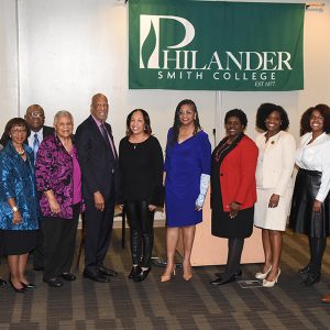 African-American men and women posing beneath "Philander Smith College" banner