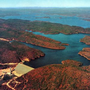 View of concrete dam and lake with islands from above