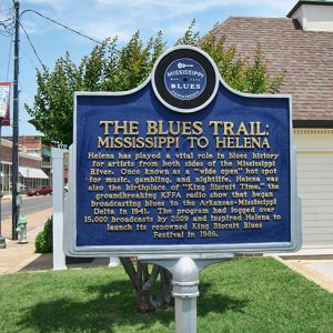 "The Blues Trail: Mississippi to Helena" sign by building on street corner