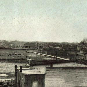 Houses and town buildings on dirt roads with telephone poles