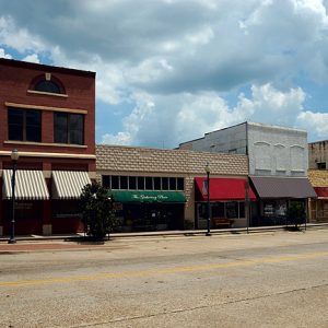 street scene with several store fronts and various colored awnings