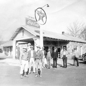 Group of white men in hats at Texaco gas station