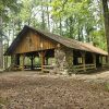 Wood and stone pavilion in forested area