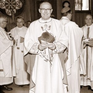 White men in white priestly vestments in a church