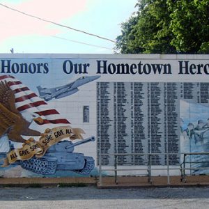 mural featuring American flag and bald eagle and tank with "Bradford Honors Our Hometown Heroes" above list of names