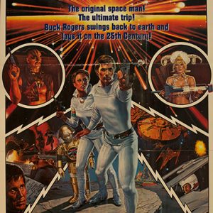 White man and woman in costume with gun and futuristic ships and characters on movie poster