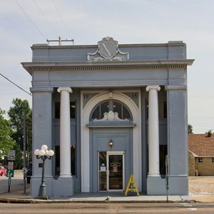 gray two story building with white columns