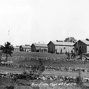 Panorama of kitchen, barracks, uniformed men, truck, and rock walls, hand-signed "C.C.C. Camp Nodak - Plainview, Ark. 11-8-33"