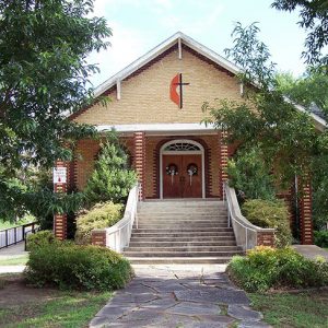 Brick church building with box gable roof and steps