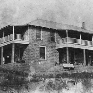 Two-story building with covered porches and balconies