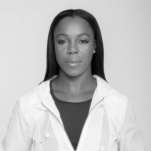 Young black woman with long hair in white jacket