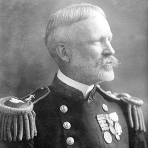 Older white man with mustache in military uniform with medals and epaulets