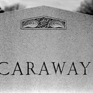 Close-up of "Caraway" grave monument with floral design on top