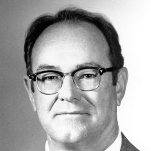 White man with glasses in suit and tie