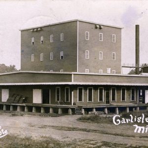 Single-story building and multistory building with flat roofs and smokestack