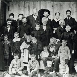 Large white family in suits and dresses  posing outdoors