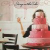 White woman sitting behind multi-tier wedding cake under "Icing on the Cake" title on book cover