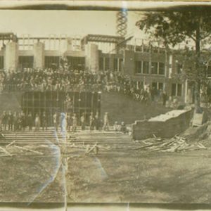 Group of people posing on steps of unfinished multistory building