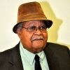 Old African-American man with hat and glasses in suit and tie