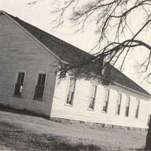 Single story wooden church building with widows and door