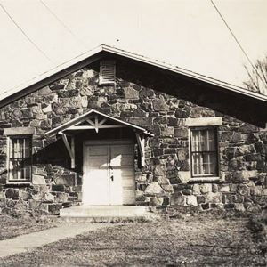 Single story stone structure with covered entrance