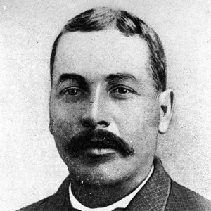 African-American man with mustache in suit and bow tie