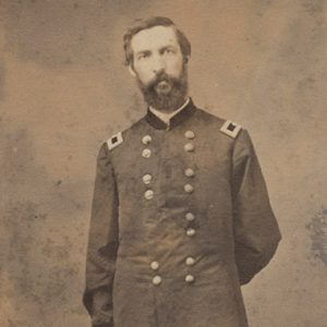 White man with beard standing in military uniform