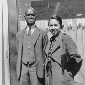 African-American man and woman in suit and long coat respectively