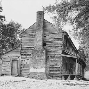 Two-story wooden inn building with brick chimney