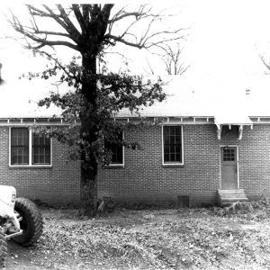 Brick building with chimney and tractor