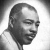 African-American man with mustache in suit and tie