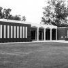 Single-story brick building with three columned entrance