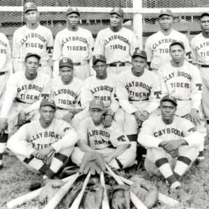 African-American men in uniforms labeled "Claybrook Tigers" pose for a group photograph with bats and gloves laid out in front of them