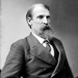 Old white man with beard in suit and tie