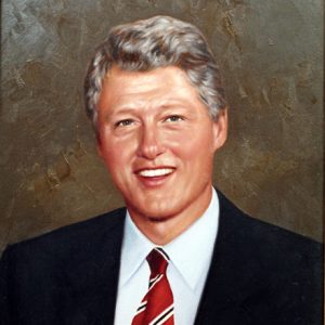 White man with gray hair in suit and striped tie