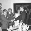 Group of white men and a woman in room meeting the governor