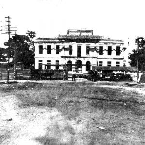 Group of men posing in front of unfinished court house