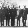 Group of older white men in suits standing together