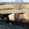 Concrete bridge with supporting column over creek