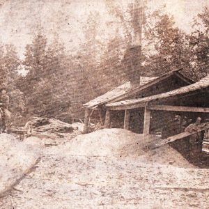 White men working at sawmill with white man on horse drawn wagon