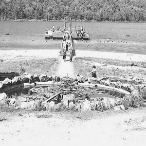 Round fountain and lake swimming area with dock