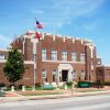 Two-story brick building with flag pole on street