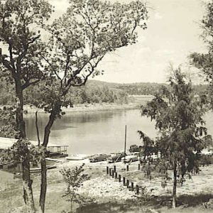 Boat dock and cars parked at edge of lake