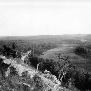 Aerial view of large creek with trees and countryside