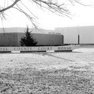 Single-story building with trees and "Cross County Court House" sign