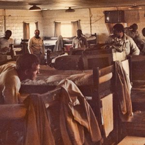 White prisoners in room with bunk beds