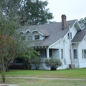 Multistory house with dormer roof and brick chimney