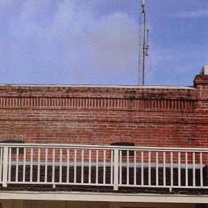 Close-up of brick storefront balcony